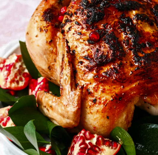 Roasted whole chicken marinated in fresh herbs and pomegranate